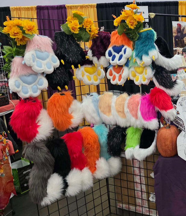 Rack of Premade Fursuit Tails and Handpaws (at Kumoricon 2025) Rack of Premade Fursuit Tails and Handpaws (at Kumoricon 2025)